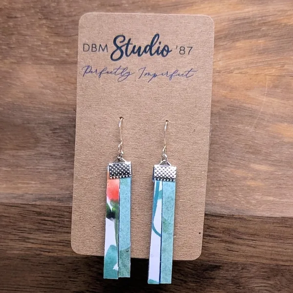 Medium split scrapbook paper and felt earrings. Half orange and green florals on white, the other half medium blue florals on blue. in silver finishes.